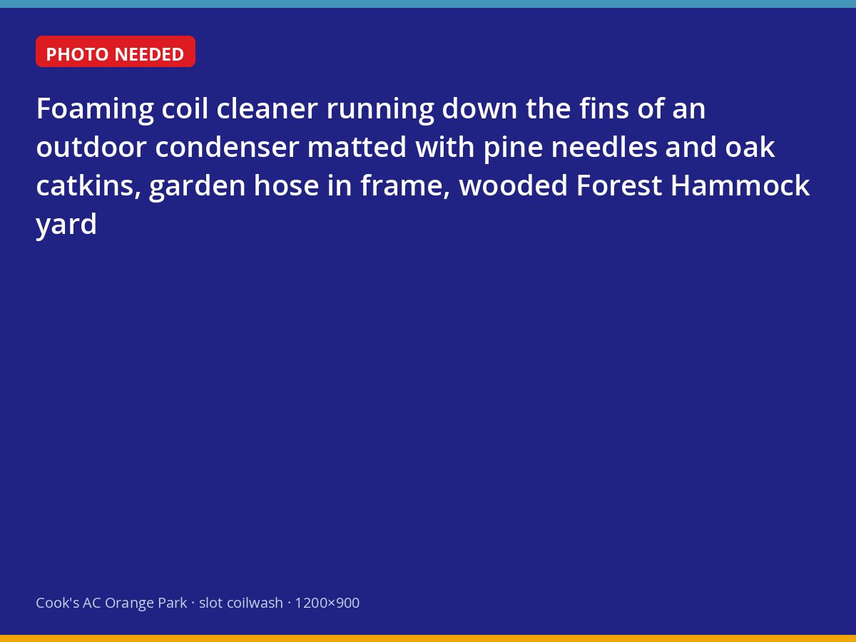Technician washing a pollen-coated condenser coil in a wooded Orange Park yard